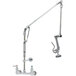 A T&S wall mounted pre-rinse faucet with a metal pipe, Roto-Flex support, and wall bracket.