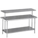An Advance Tabco stainless steel middle mount shelf with two shelves above a work table.