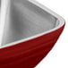 A Dazzle Red stainless steel square bowl by Vollrath on a counter.