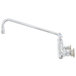 A T&S chrome wall mounted pantry faucet with a long silver swing nozzle.