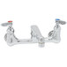 A chrome T&S wall mount pantry faucet with two handles and a swing nozzle.