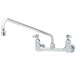 A T&S chrome wall mounted pantry faucet with two handles and an 18" swing nozzle.