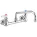 A white T&S wall mounted pantry faucet with two chrome handles.