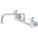 A T&S chrome wall mounted pantry faucet with two handles and two faucets.
