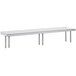 A stainless steel rectangular shelf with two legs on a metal table.