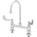A chrome T&S deck-mounted faucet with gooseneck nozzle and wrist handles.