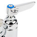 A chrome T&S wall mount faucet with blue handles.