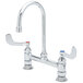 A T&S chrome deck-mounted surgical sink faucet with two wrist action handles and a gooseneck spout.