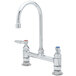 A chrome T&S deck-mounted faucet with two handles.