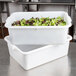 A white Tablecraft plastic food storage container with lettuce in it.