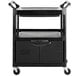 A black Rubbermaid plastic utility cart with lockable doors and sliding drawer on wheels.