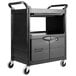 A black Rubbermaid plastic utility cart with lockable doors and a sliding drawer on wheels.