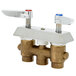 A close-up of a T&S concealed mixing faucet with brass check valves and two handles on a white background.