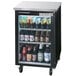 A Beverage-Air black back bar refrigerator with shelves full of beer bottles.
