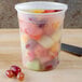 A translucent plastic container filled with fruit salad.