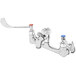 A chrome T&S wall mount mop sink faucet with 6" wrist action handles and vacuum breakers, and red and blue indexes.