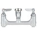 A T&S silver wall mount mop sink faucet with chrome handles.