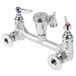 A T&S chrome wall mount mop sink faucet with silver knobs.