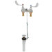 A T&S deck mount medical faucet with 4" wrist action handles and a pop up drain.