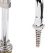 A chrome T&S deck mount faucet with serrated nozzle and wrist action handles.