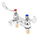 A T&S chrome deck mount medical faucet with 4" wrist action handles in white.