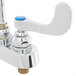 A chrome T&S deck mount faucet with blue wrist action handles.
