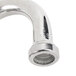 A close-up of a T&S metal wall mount faucet with a gooseneck spout.