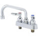A T&S chrome deck-mount faucet with two handles and a swing nozzle.