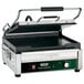 A Waring commercial panini grill with a green handle.