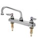 A T&S chrome deck-mount faucet with two handles and a swing nozzle.