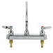A chrome T&S deck mount faucet with two handles and a 14" swing nozzle.