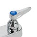 A chrome T&S deck-mount faucet with blue handles and a blue button.