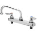 A chrome T&S deck-mount faucet with two silver wrist-action handles.
