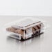 A Dart clear hinged plastic container filled with chocolate cookies.