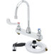 A T&S chrome deck-mount faucet with gooseneck spout, wrist action handles, and sidespray.