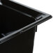 A close-up of a black Vollrath plastic food pan with a lid.