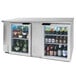 A Beverage-Air stainless steel back bar refrigerator with bottles of alcohol inside.