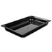 A Vollrath black plastic food pan on a counter.
