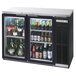 A Beverage-Air black counter height back bar cooler filled with bottles of beer.