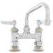 A T&S chrome deck mount sink faucet with two handles and a swing nozzle.