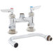 A white T&S deck mount sink faucet with chrome and silver accents.