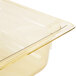 A Vollrath amber plastic food pan with a lid on it.