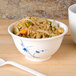 A blue Thunder Group Blue Bamboo melamine rice bowl filled with rice and vegetables on a wooden surface.