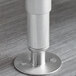 A stainless steel flanged foot for an Advance Tabco dishtable.
