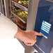 A person using a touch screen to set the temperature on an Alto-Shaam Quickchiller.
