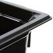 A black Vollrath high heat plastic food pan on a counter.