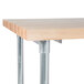 A wood table with metal legs and a metal undershelf.