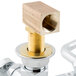 A T&S brass wall mounted faucet with brass lever handles.