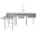 A stainless steel U-shaped dishtable with a faucet over a sink.