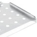 A stainless steel tray with a false bottom and holes.